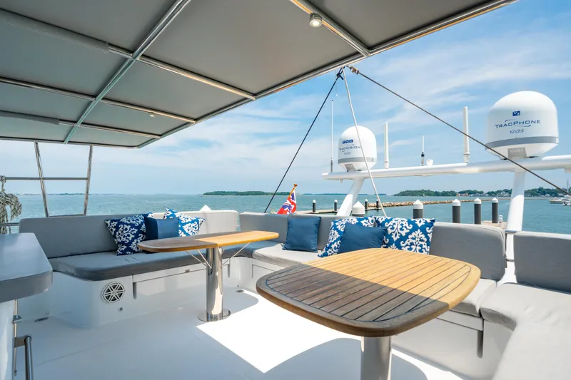 Sur L'eau Yacht Photos Pics Luxurious 2008 Privilege 745 yacht deck with seating, tables, and ocean view.