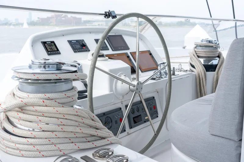 Sur L'eau Yacht Photos Pics Helm of 2008 Privilege 745 yacht with navigation instruments and coiled ropes.
