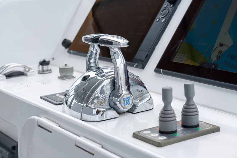 Sur L'eau Yacht Photos Pics Control panel of a 2008 Privilege 745 yacht with navigation screens and throttle levers.