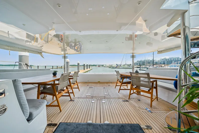 Sur L'eau Yacht Photos Pics Spacious deck of 2008 Privilege 745 yacht with elegant seating and marina view.