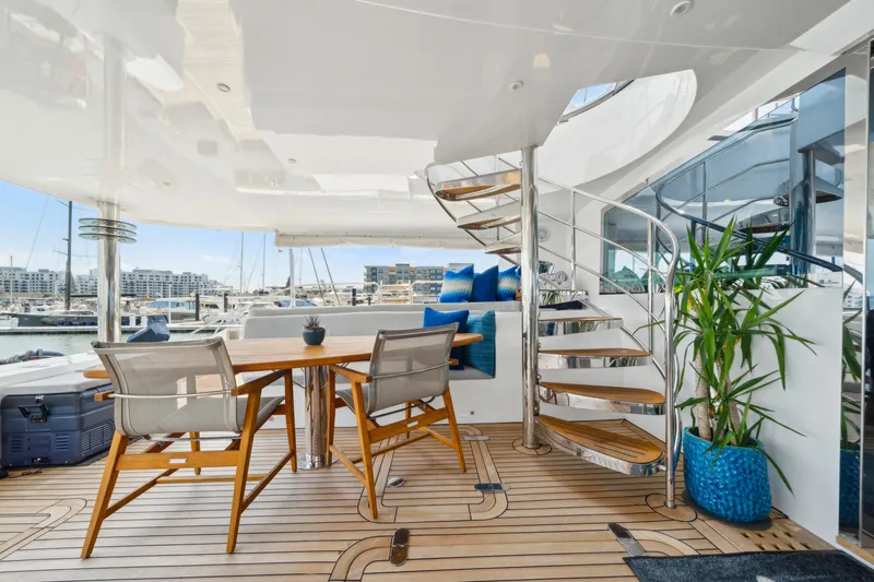 Sur L'eau Yacht Photos Pics Luxurious 2008 Privilege 745 yacht interior with wooden deck, spiral staircase, and elegant seating area.