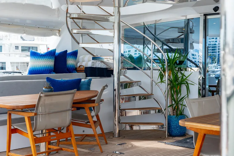 Sur L'eau Yacht Photos Pics Luxurious 2008 Privilege 745 yacht interior with spiral staircase, seating, and decor.