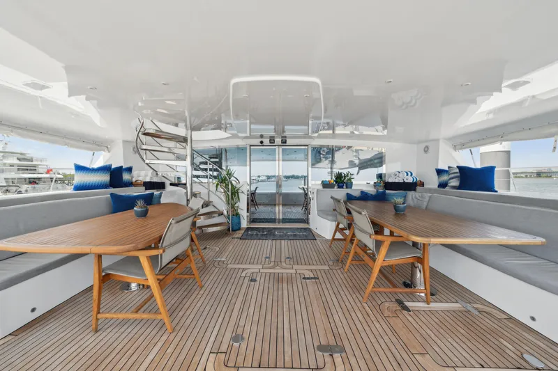 Sur L'eau Yacht Photos Pics Luxurious 2008 Privilege 745 yacht interior with elegant seating and wooden tables.
