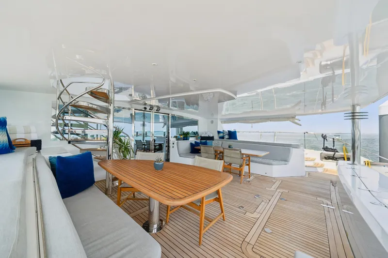 Sur L'eau Yacht Photos Pics Luxurious 2008 Privilege 745 yacht deck with elegant seating and spiral staircase.