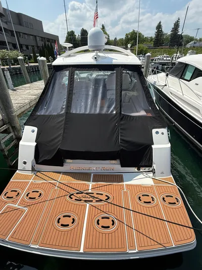 Midnight Run Yacht Photos Pics 2009 Sea Ray 43 Sundancer docked with covered cockpit and teak swim platform.