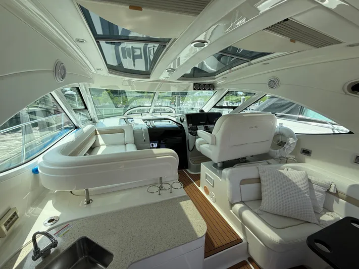 Midnight Run Yacht Photos Pics Luxurious interior of a 2009 Sea Ray 43 Sundancer yacht with plush seating and modern amenities.