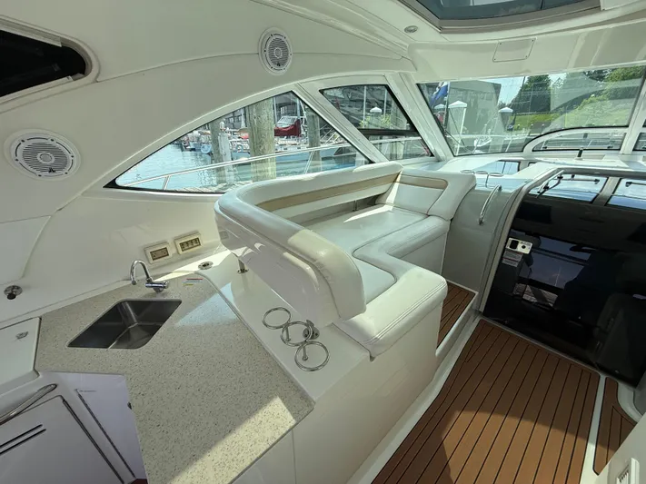 Midnight Run Yacht Photos Pics Interior of 2009 Sea Ray 43 Sundancer yacht with seating and kitchenette.