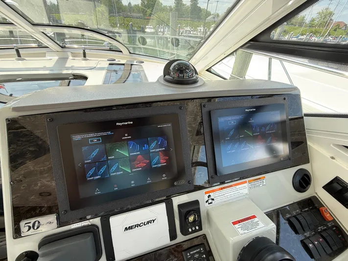 Midnight Run Yacht Photos Pics Helm of 2009 Sea Ray 43 Sundancer with dual Raymarine displays and Mercury controls.