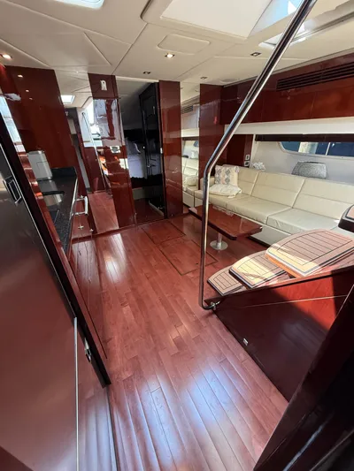 Midnight Run Yacht Photos Pics Luxurious interior of 2009 Sea Ray 43 Sundancer yacht with polished wood and white seating.