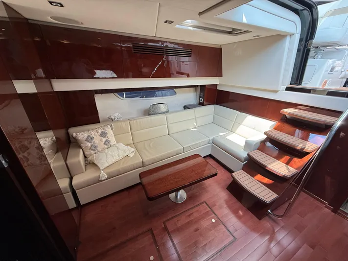 Midnight Run Yacht Photos Pics Luxurious interior of 2009 Sea Ray 43 Sundancer yacht with plush seating and wooden accents.