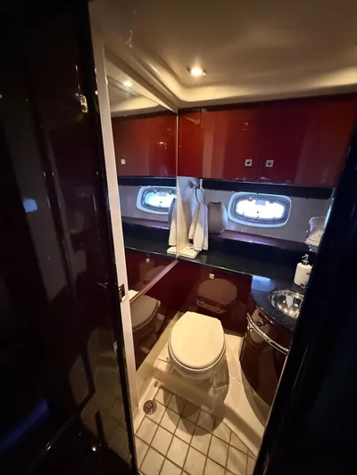 Midnight Run Yacht Photos Pics Luxurious bathroom in 2009 Sea Ray 43 Sundancer yacht with modern fixtures and elegant design.