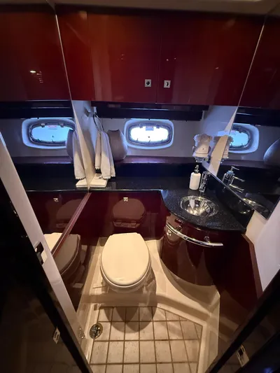 Midnight Run Yacht Photos Pics Luxurious bathroom in 2009 Sea Ray 43 Sundancer yacht with elegant fixtures and porthole windows.