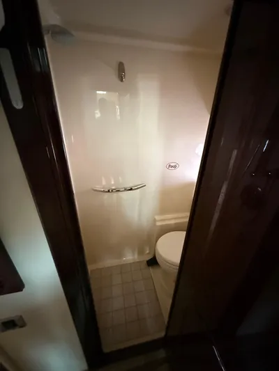 Midnight Run Yacht Photos Pics Bathroom interior of 2009 Sea Ray 43 Sundancer yacht, featuring shower and toilet.