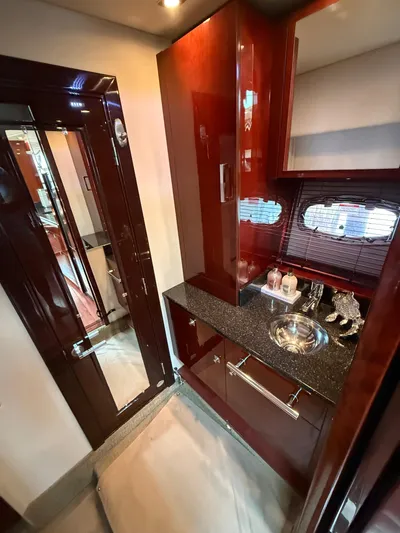Midnight Run Yacht Photos Pics Luxurious bathroom interior of 2009 Sea Ray 43 Sundancer yacht with sleek wood finishes.