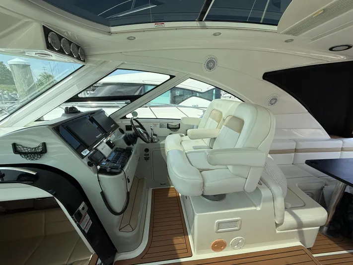 Midnight Run Yacht Photos Pics Interior of 2009 Sea Ray 43 Sundancer yacht with luxurious seating and modern dashboard.