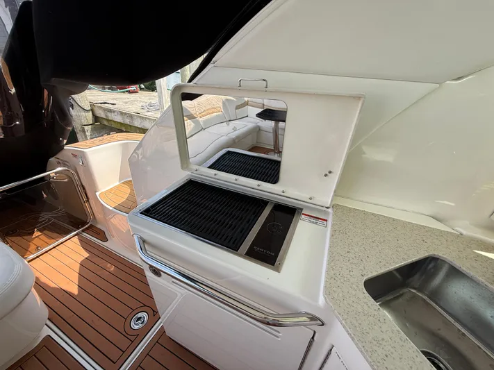 Midnight Run Yacht Photos Pics Outdoor kitchen on 2009 Sea Ray 43 Sundancer yacht with grill and sink.