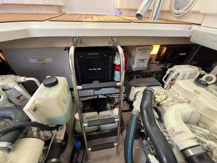 Midnight Run Yacht Photos Pics Engine compartment of a 2009 Sea Ray 43 Sundancer with visible components and ladder.