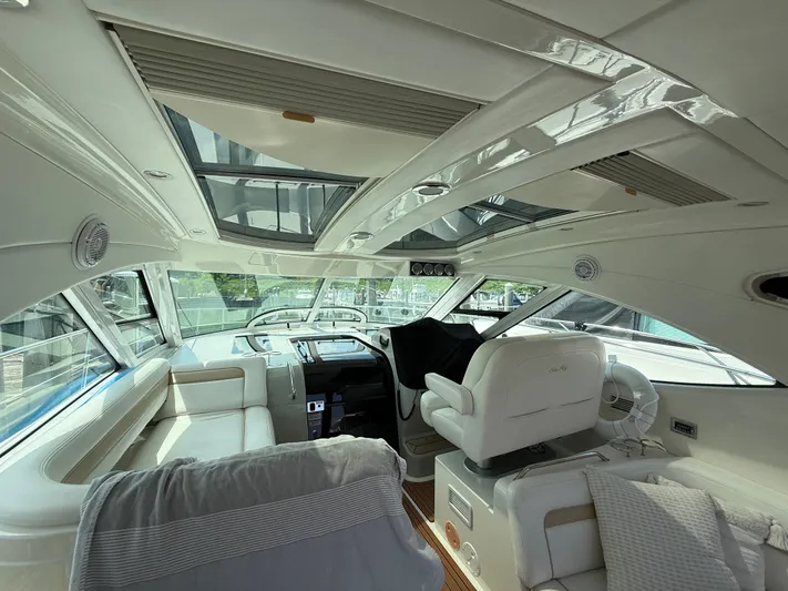 Midnight Run Yacht Photos Pics Interior of 2009 Sea Ray 43 Sundancer yacht with luxurious seating and helm.