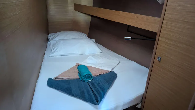 Nevis Yacht Photos Pics Cozy cabin bed in 2017 Dufour 460 Grand Large yacht with neatly arranged towels.