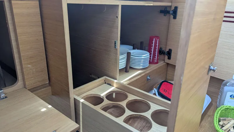 Nevis Yacht Photos Pics Interior of 2017 Dufour 460 Grand Large yacht with wooden cabinets and kitchenware.