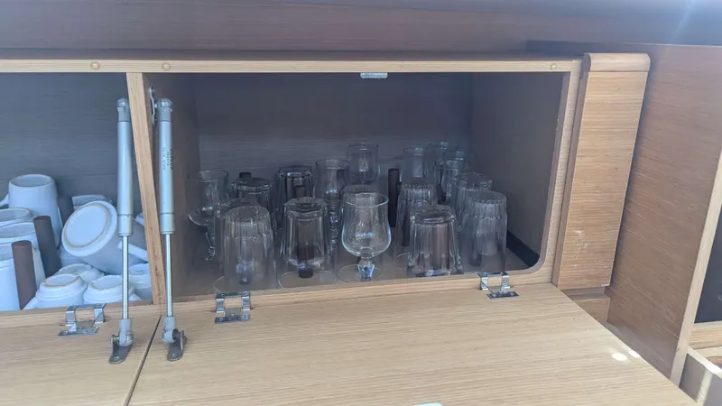 Nevis Yacht Photos Pics Cabinet with glassware and cups on a 2017 Dufour 460 Grand Large yacht.