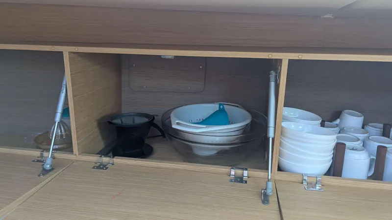 Nevis Yacht Photos Pics Cabinet interior with kitchenware on a 2017 Dufour 460 Grand Large yacht.