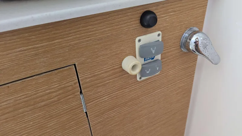 Nevis Yacht Photos Pics Wooden cabinet with Jabsco controls and chrome handle on a 2017 Dufour 460 Grand Large yacht.