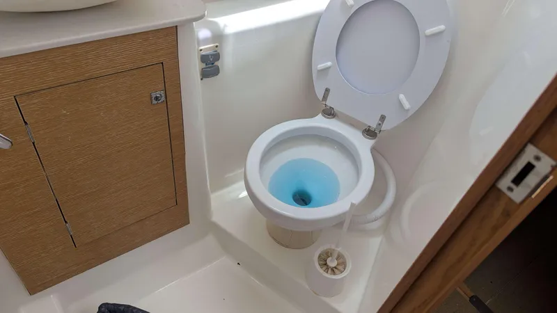 Nevis Yacht Photos Pics Bathroom on 2017 Dufour 460 Grand Large yacht with toilet and wooden cabinet.