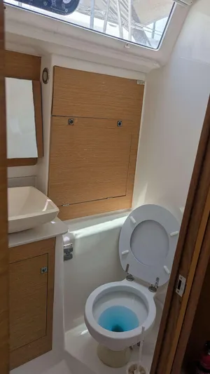Nevis Yacht Photos Pics Bathroom interior of 2017 Dufour 460 Grand Large yacht with wooden cabinetry.