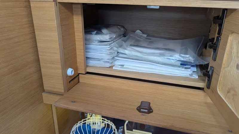 Nevis Yacht Photos Pics Wooden cabinet with documents inside a 2017 Dufour 460 Grand Large sailboat.