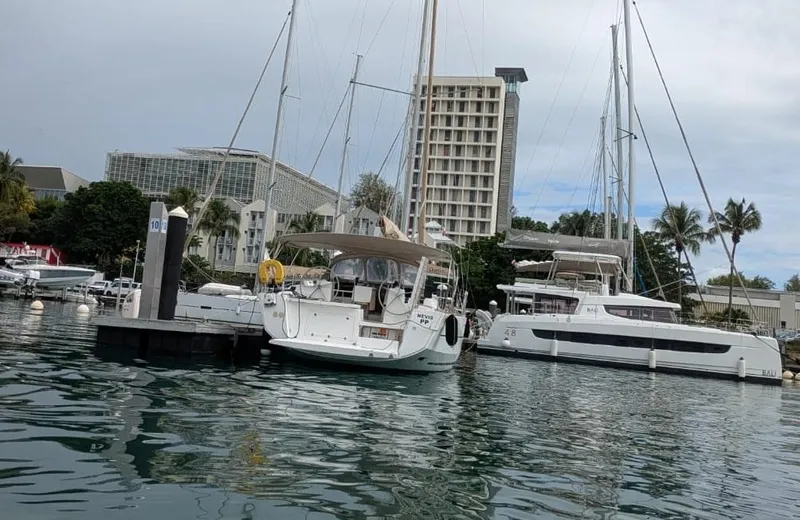 Nevis Yacht Photos Pics Dufour 460 Grand Large 2017 yacht docked in a marina with nearby buildings.