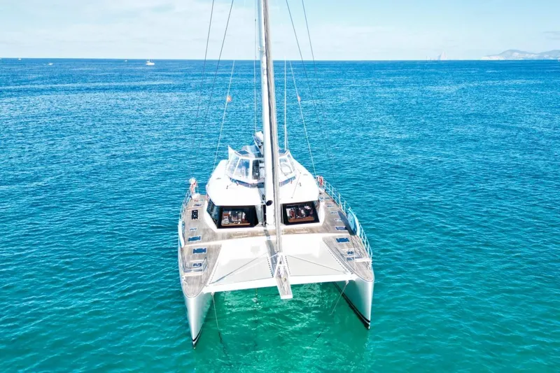 Sunnyacht Yacht Photos Pics 2008 Sunreef 62 catamaran sailing on clear blue ocean waters.