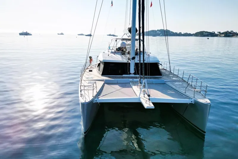 Sunnyacht Yacht Photos Pics 2008 Sunreef 62 catamaran on calm water, surrounded by distant yachts.