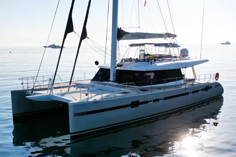 Sunnyacht Yacht Photos Pics 2008 Sunreef 62 catamaran sailing on calm waters, showcasing sleek design and modern features.