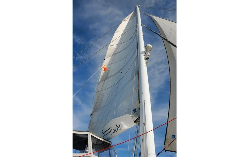 Sunnyacht Yacht Photos Pics Sailing yacht Sunreef 62, 2008 model, with sails unfurled against a blue sky.