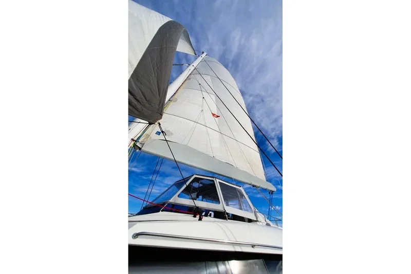 Sunnyacht Yacht Photos Pics Sailing yacht Sunreef 62, 2008 model, with sails unfurled against a blue sky.