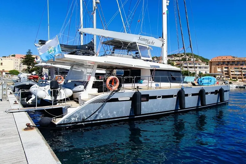 Sunnyacht Yacht Photos Pics Luxury Sunreef 62 yacht docked at marina, 2008 model, clear blue sky background.