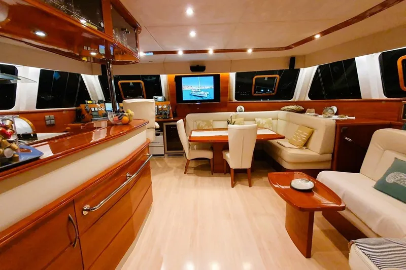 Sunnyacht Yacht Photos Pics Luxurious interior of 2008 Sunreef 62 yacht with elegant wood finishes and plush seating.