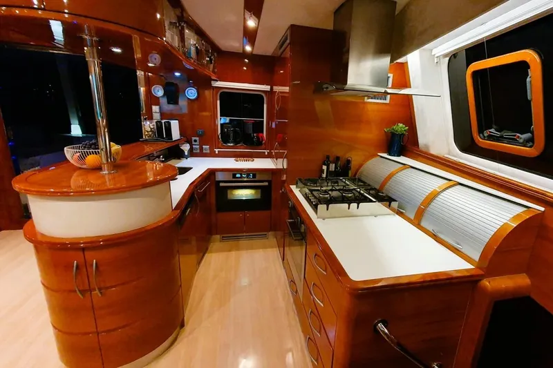 Sunnyacht Yacht Photos Pics Luxurious 2008 Sunreef 62 yacht kitchen with modern appliances and elegant wood finishes.