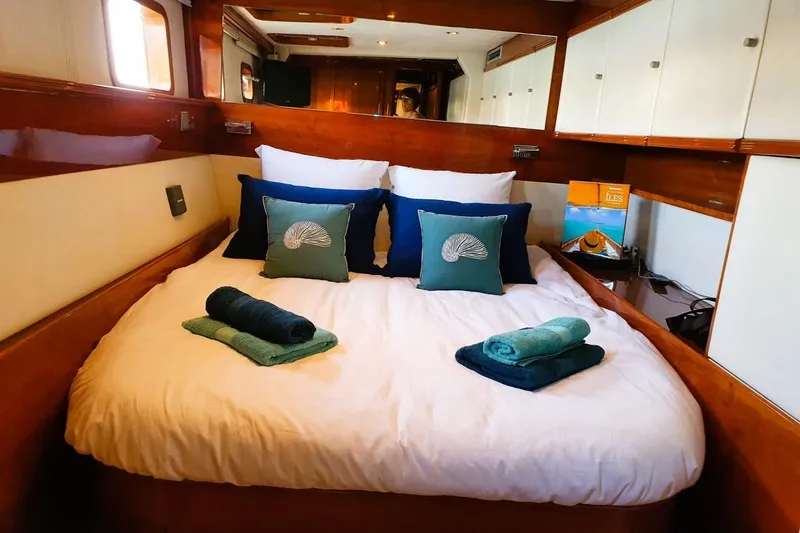 Sunnyacht Yacht Photos Pics Luxurious cabin interior of 2008 Sunreef 62 yacht with neatly arranged bed and decor.