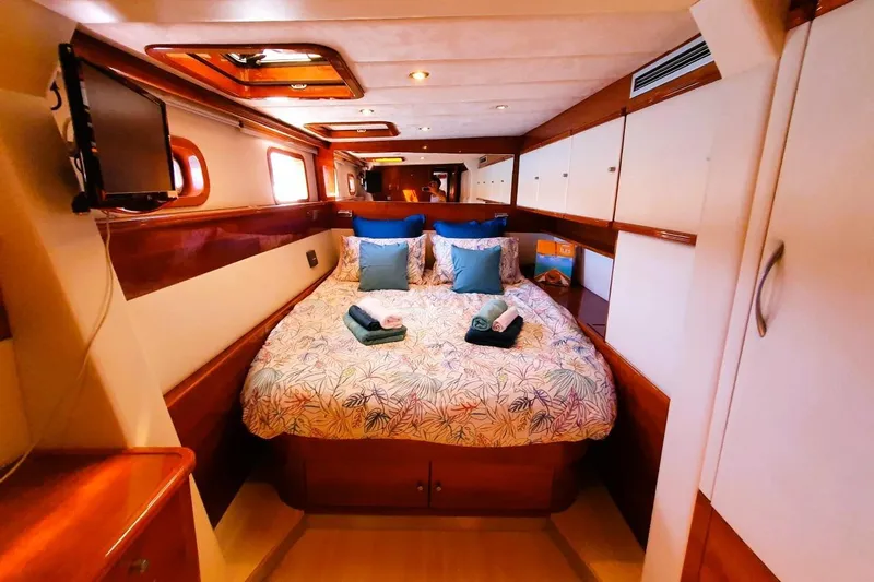 Sunnyacht Yacht Photos Pics Luxurious cabin interior of 2008 Sunreef 62 yacht with cozy bed and elegant decor.