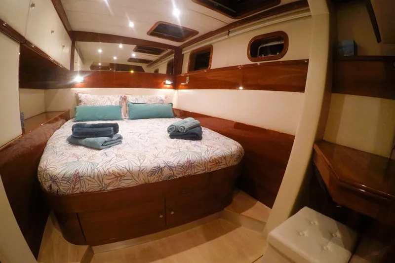 Sunnyacht Yacht Photos Pics Luxurious cabin interior of 2008 Sunreef 62 yacht with cozy bed and elegant wood finish.
