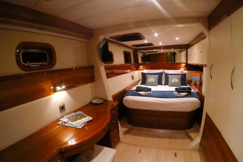 Sunnyacht Yacht Photos Pics Luxurious cabin interior of 2008 Sunreef 62 yacht with elegant wood finishes and cozy bedding.