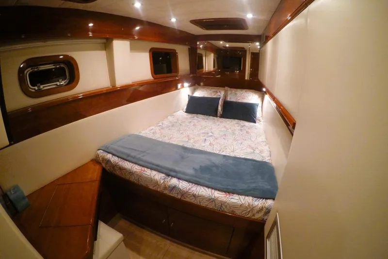 Sunnyacht Yacht Photos Pics Luxurious cabin interior of 2008 Sunreef 62 yacht with cozy bed and elegant wood finish.