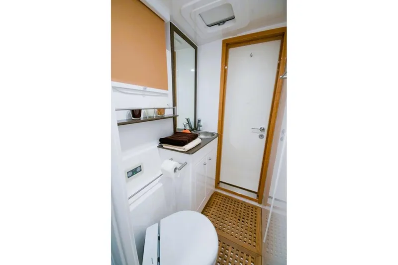 Sunnyacht Yacht Photos Pics Bathroom interior of 2008 Sunreef 62 yacht, featuring modern fixtures and wooden accents.