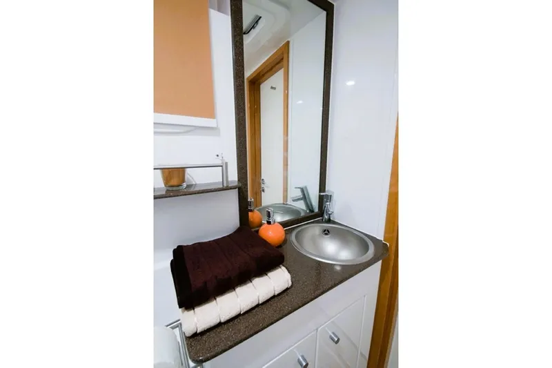 Sunnyacht Yacht Photos Pics Luxurious bathroom interior of 2008 Sunreef 62 yacht with modern sink and mirror.