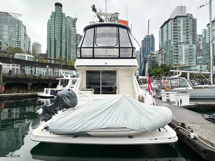  Yacht Photos Pics 2012 Sea Ray 450 Sedan Bridge yacht docked in urban marina with covered equipment.