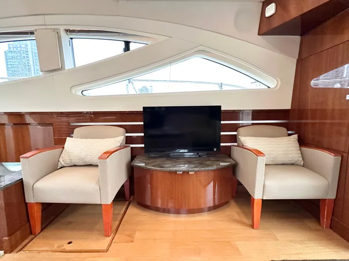  Yacht Photos Pics Interior of 2012 Sea Ray 450 Sedan Bridge with chairs and TV.