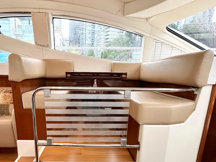  Yacht Photos Pics Interior of 2012 Sea Ray 450 Sedan Bridge with beige seating and wooden accents.
