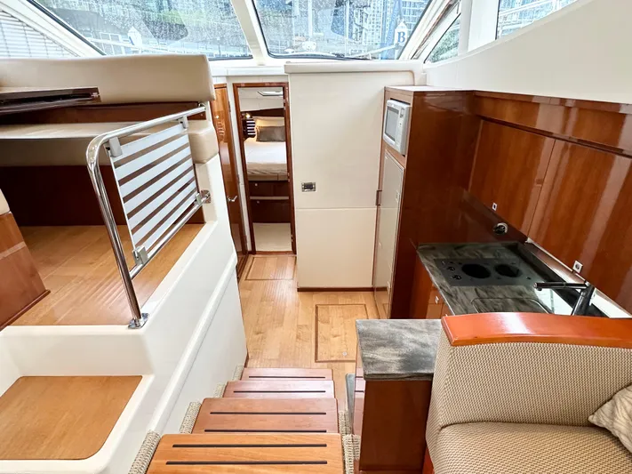  Yacht Photos Pics Interior of 2012 Sea Ray 450 Sedan Bridge yacht with modern kitchen and seating area.